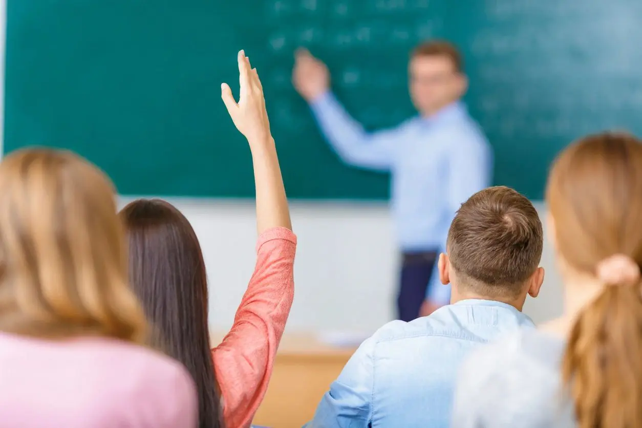 A group of people in front of a chalkboard.